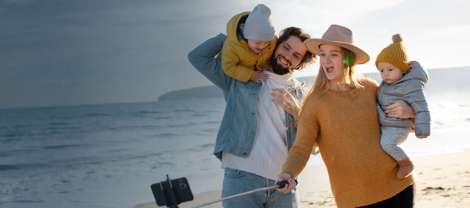 A young family enjoying time together on the beach -- Scharf Law, P.C.